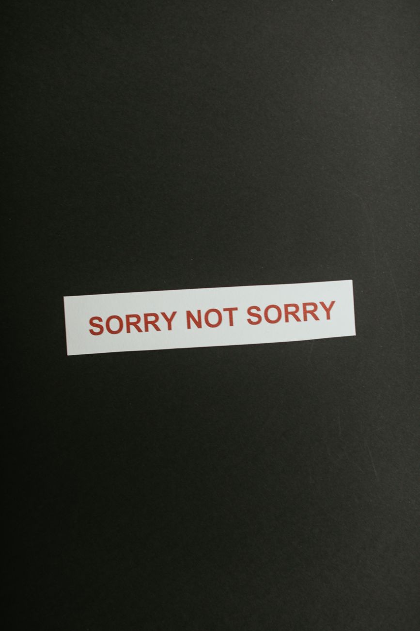 sorry not sorry phrase on black background